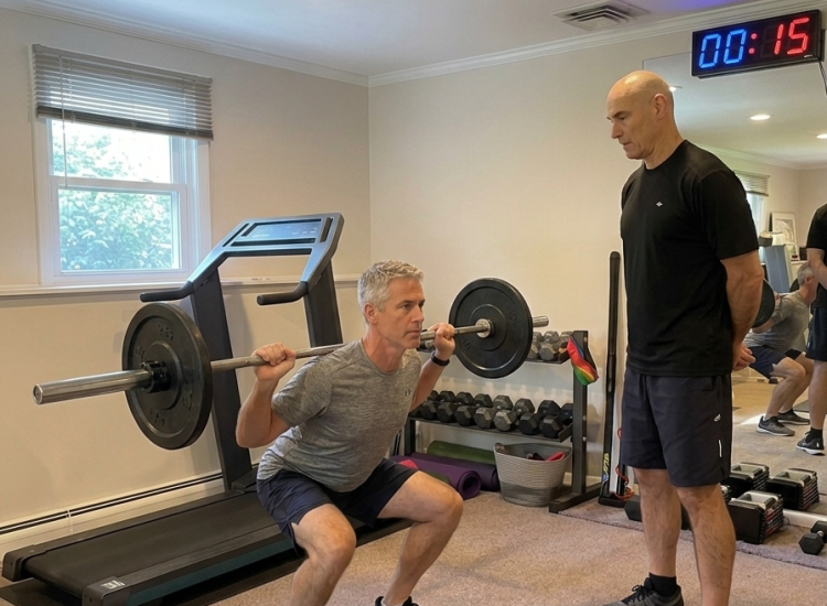 Greenwich Personal Training Carlos Perez guiding a Barbell Squat using Time Under Tension